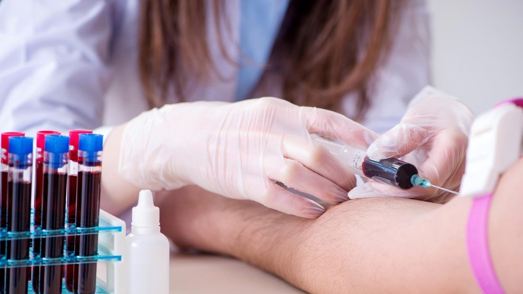Phlebotomist collecting blood sample from patient